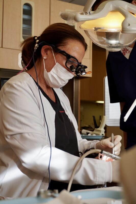 cosmetic dental dr. bodneva working with a patient in the dental office